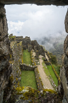 Sayacmarca archaeological site in Peru on the Inca Trail, Urubamba Province, Machupicchu, in the clouds of morning fog, Incan culture