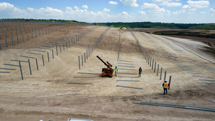 Piling machine in solar farm construction during 2024, shot from drone
