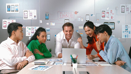 Shot of group of smart diverse business team working together on a laptop. Group of diverse...