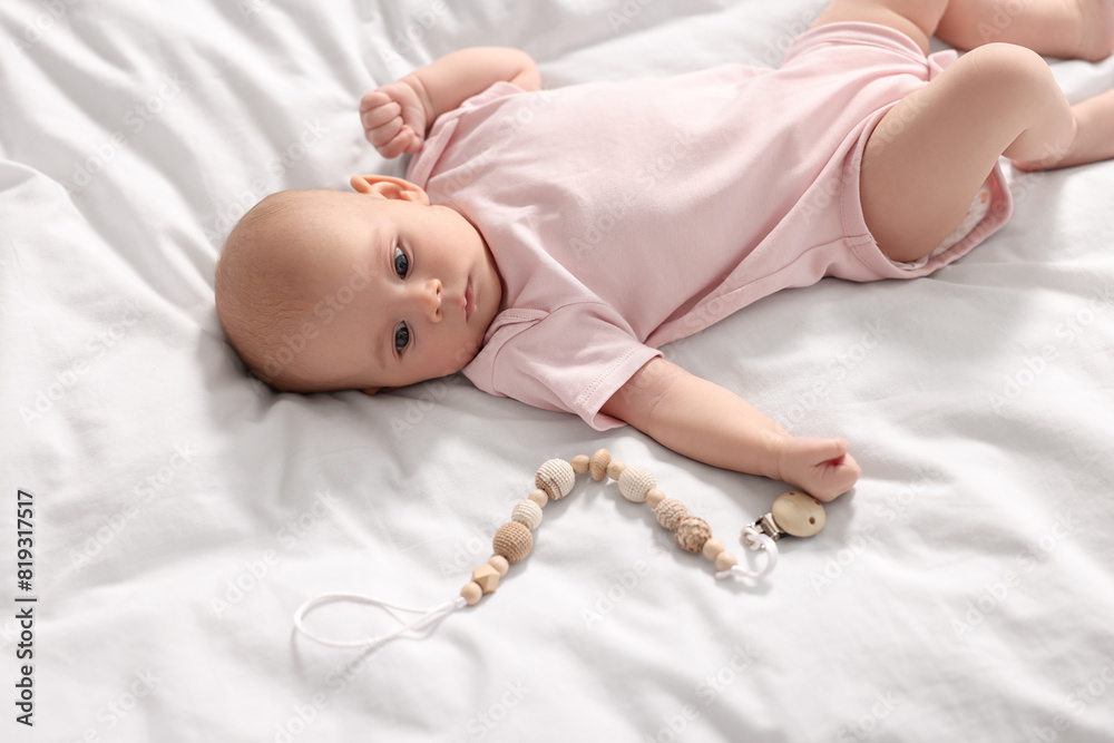 Canvas Prints Cute little baby with toy lying on white sheets