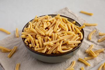 Dry Casarecce Pasta in a Bowl, side view.