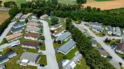 Overhead aerial view of a suburban Mobile, Prefab, Manufactured, neighborhood park, featuring rows...