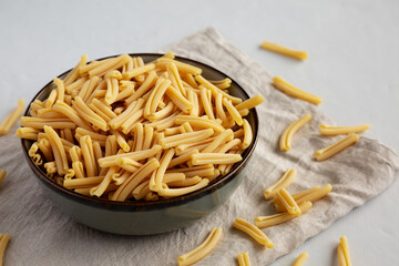 Dry Casarecce Pasta in a Bowl, side view.