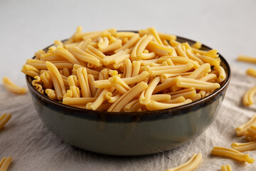 Dry Casarecce Pasta in a Bowl, side view.