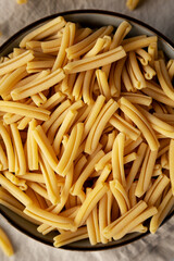 Dry Casarecce Pasta in a Bowl, top view. Close-up.
