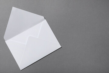 Letter envelope on grey background, top view. Space for text