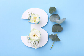 Paper number 3, beautiful flowers and eucalyptus branch on light blue background, top view