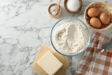 Making shortcrust pastry. Different ingredients for dough and whisk on white marble table, flat lay. Space for text