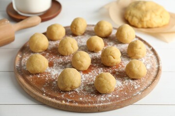 Shortcrust pastry. Raw dough balls on white wooden table
