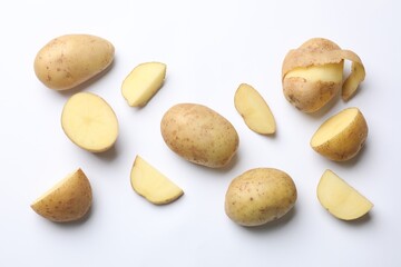 Fototapeta premium Fresh raw potatoes on white background, flat lay