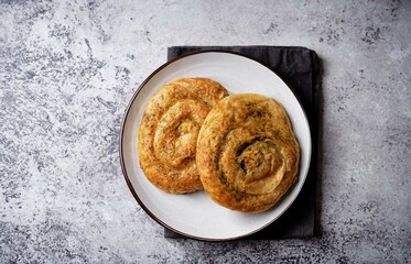 Spiral filo dough Greek pie with filling in a plate