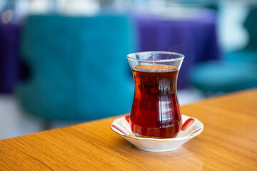Turkish black tea in a glass cup on the table.
