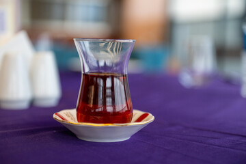 Half a glass of Turkish tea on the table.