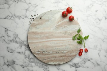 Cutting board, parsley, pepper and tomatoes on white marble table, flat lay. Space for text