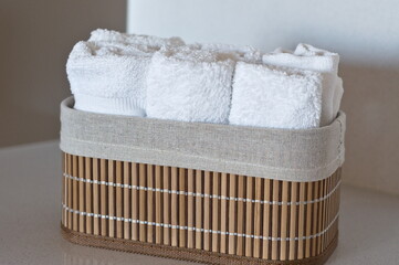 copy space, white textile hand towels in bamboo box isolated