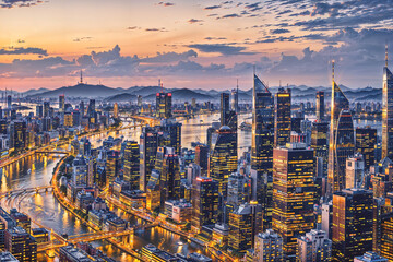 Obraz premium a view of a city at sunset from the top of a skyscraper in the middle of the city with lights : Generative AI
