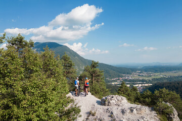 Biker couple after electric mountain bike ride enjoying the spectacular view and success, aerial...