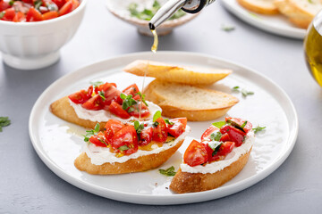 Fresh tomato bruschetta with olive oil drizzle