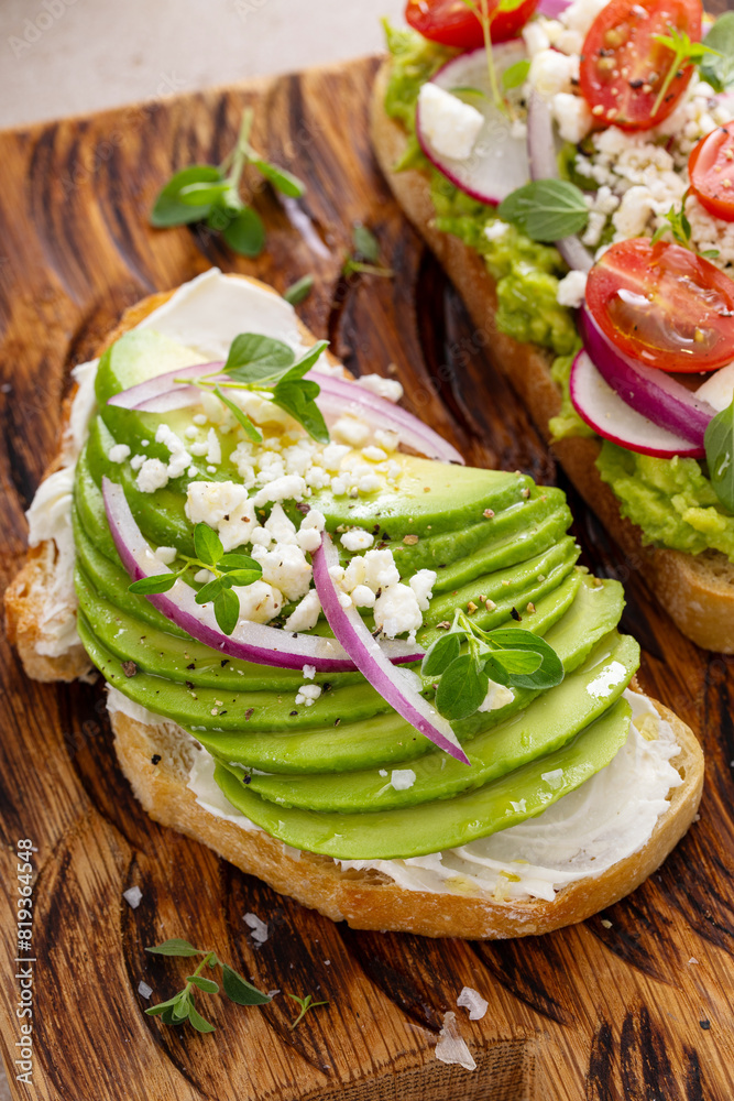 Wall mural fresh avocado toasts on wooden board