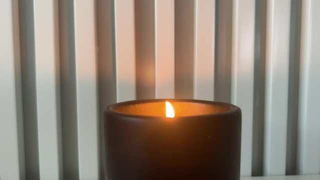 candle in a black candlestick on a white background.