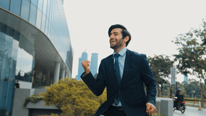 Dancing business man walking and hold bag while dancing at park. Happy funny project manager moving...