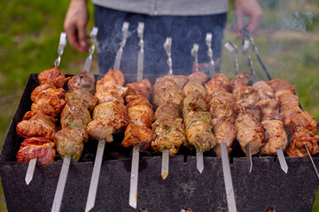 Grilling shashlik on barbecue grill.
