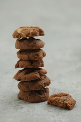 Stack of chocolate cookies or chocolate biscuit on grey background. Selective focus. Kue kering