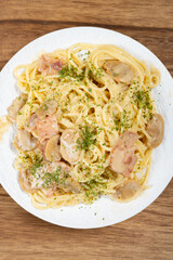top view spaghetti with creamed mushroom and bacon sauce at vertical composition