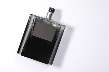 Luxury men`s perfume in bottle on white background, top view. Space for text