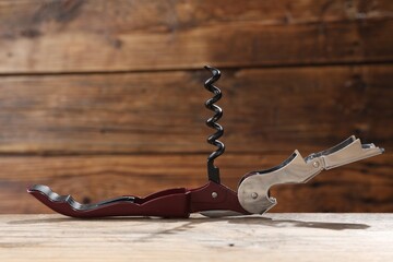 One corkscrew (sommelier knife) on wooden table, closeup