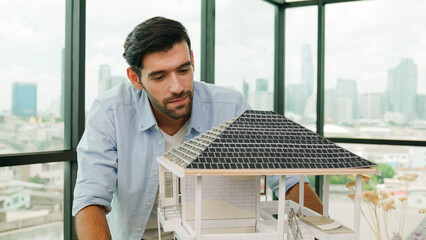 Professional architect engineer check, inspect, look architectural model at modern office with...