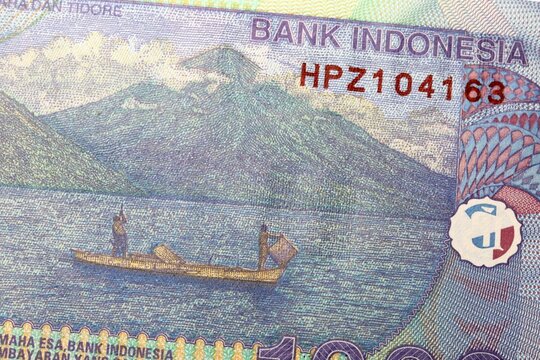 Rupiah Banknote type currency in Indonesia - Maitara and Tidore Islands, with fishermen on a boat