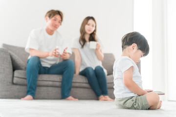 家で子供にスマホを自由に使わせる日本人夫婦
