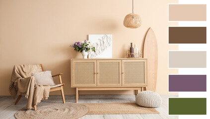 Wooden chest of drawers, surfboard and armchair near beige wall in room. Different color patterns