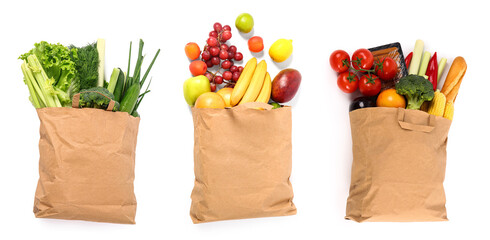 Set of paper shopping bags with fresh products on white background