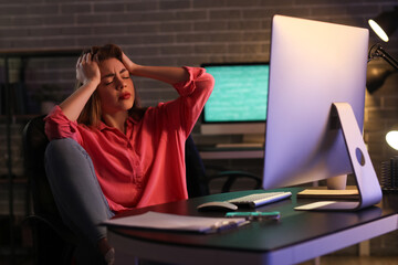 Stressed female programmer working in office at night