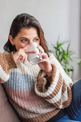 Woman in a wool coat having a cup of coffee