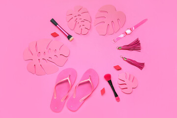 Fototapeta premium Frame made of female accessories, flip-flops and paper palm leaves on pink background