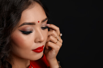 Fototapeta premium Beautiful young Indian woman in sari on black background