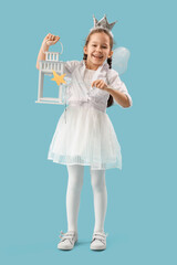 Cute little fairy with wand and lantern on blue background