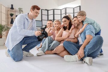 Big family looking at taken pictures in studio