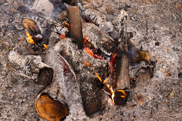 Burning boards and coals in a fire.