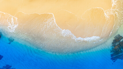 Fototapeta premium Top view nature of the beach and sea Summer with sunshine, sandy beaches, clear blue waters sparkling against the blue sky. on island with good ecology and environment Background for summer vacation