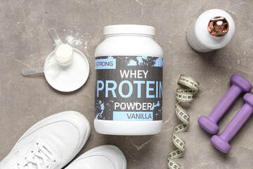 Composition with protein powder, shoes and dumbbells on grunge background