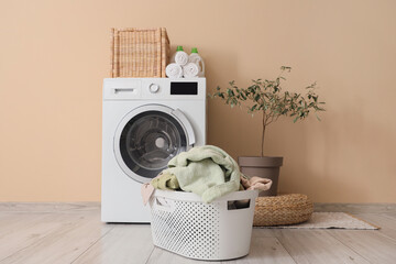 Interior of laundry room with basket and washing machine