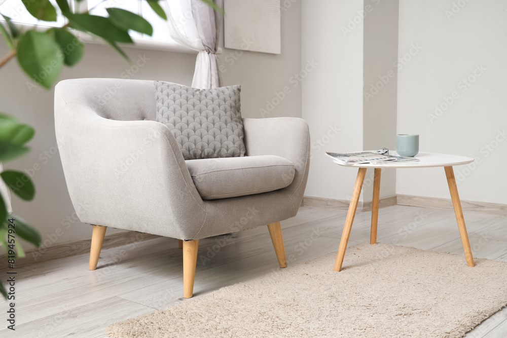 Wall mural interior of light living room with grey armchair and table