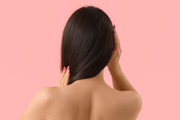 Fototapeta premium Young woman with beautiful hair on pink background, back view