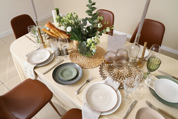 Beautiful table setting with eustoma flowers for wedding celebration in room