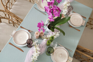 Beautiful table setting with orchid flower for wedding celebration in room, top view
