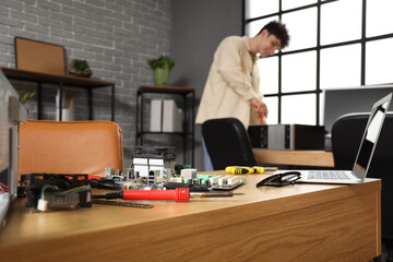 Disassembled computer parts on table in service center, closeup